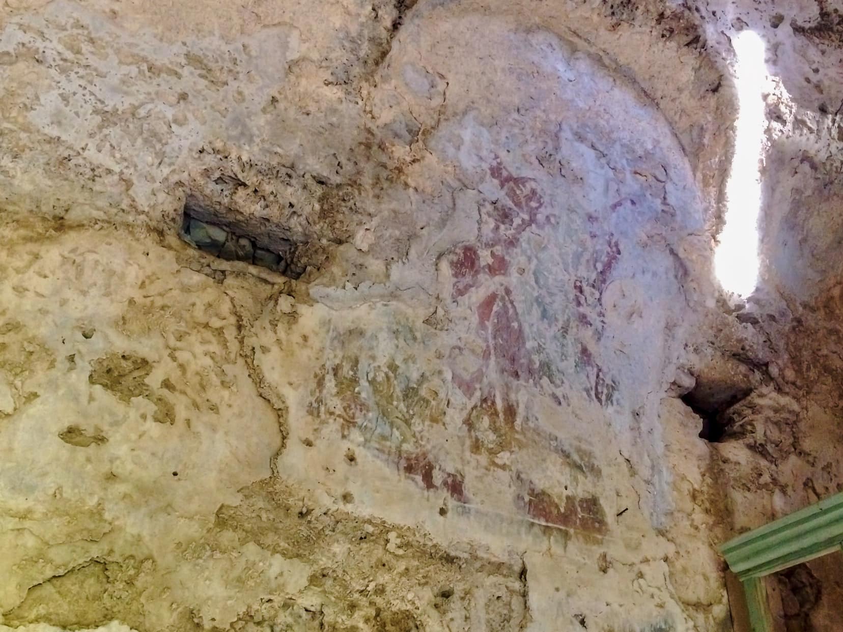 faded fresco on an old stone inner wall