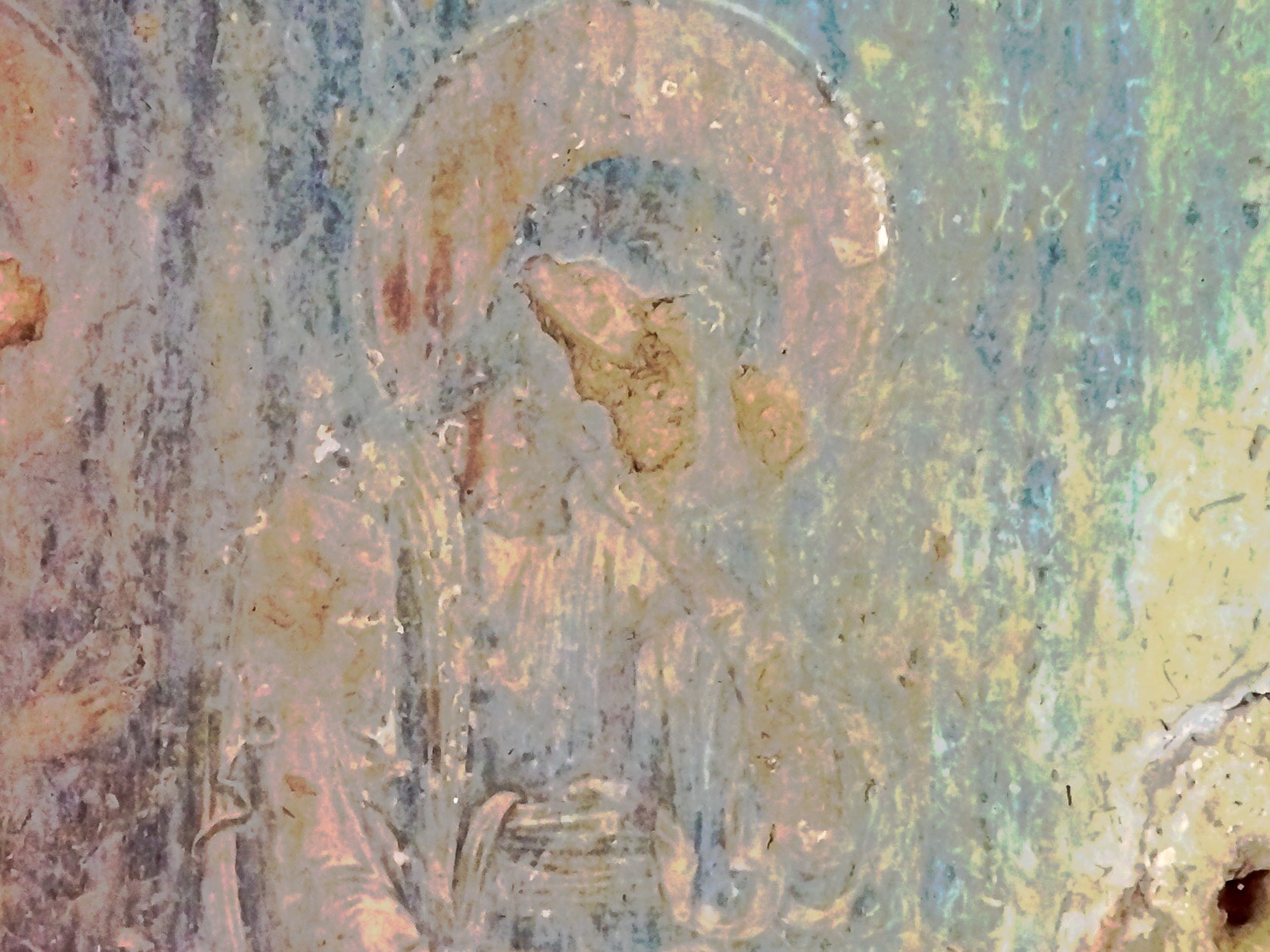 close up of a coloured faded fresco on a stone wall