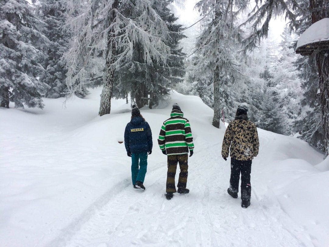 3-men-walking-a-snowy-trail