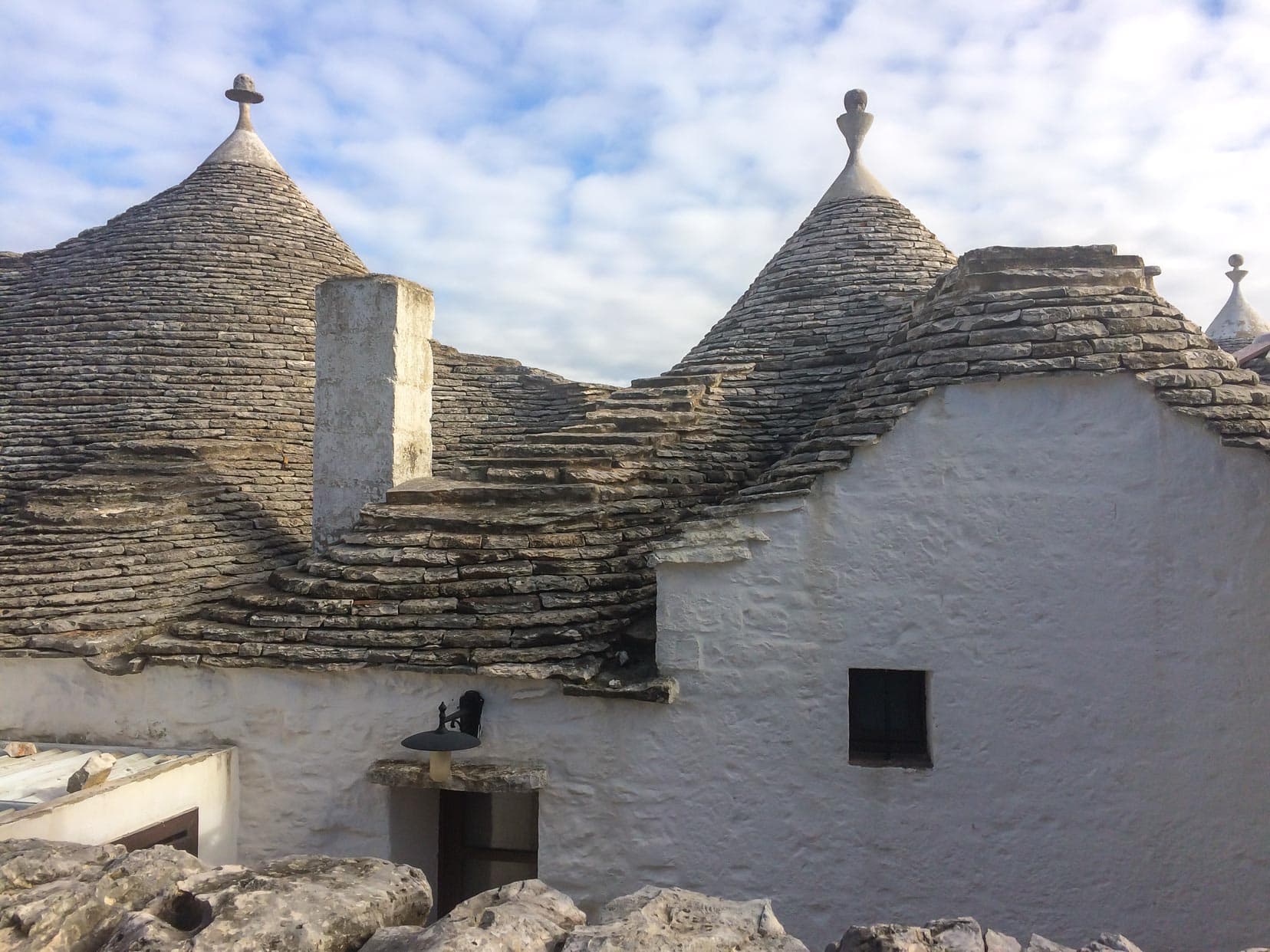 three trulli roofs with limestone slabs 