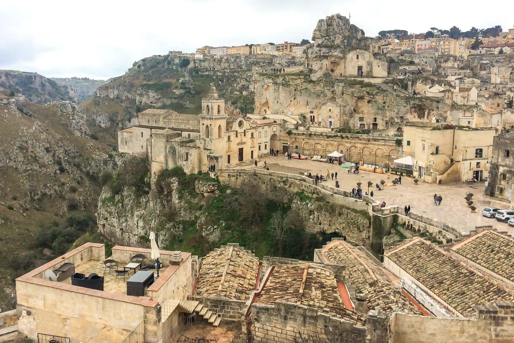 Matera view of cream coloured old buidings and ravine from above