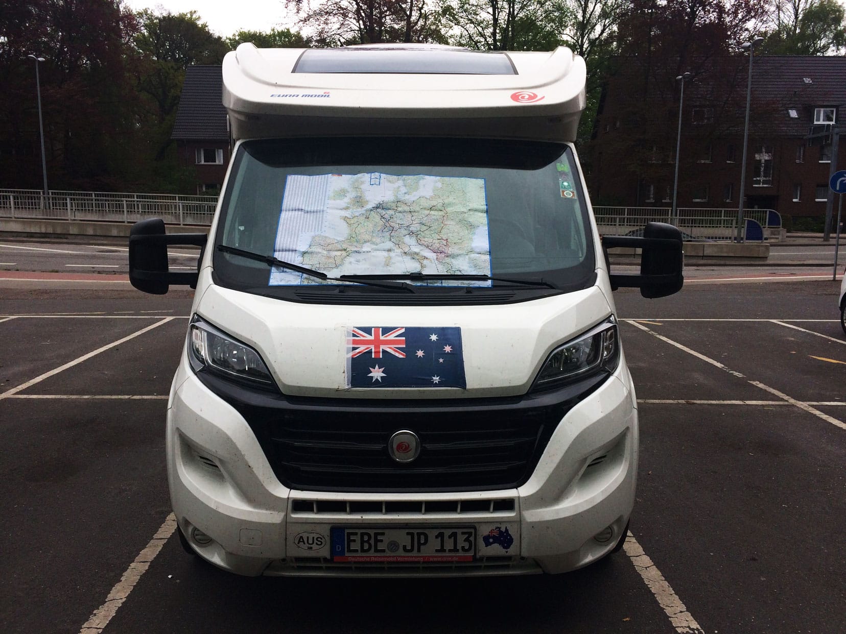 Front of motorhome from outside with a Europe map and our route in black on the map