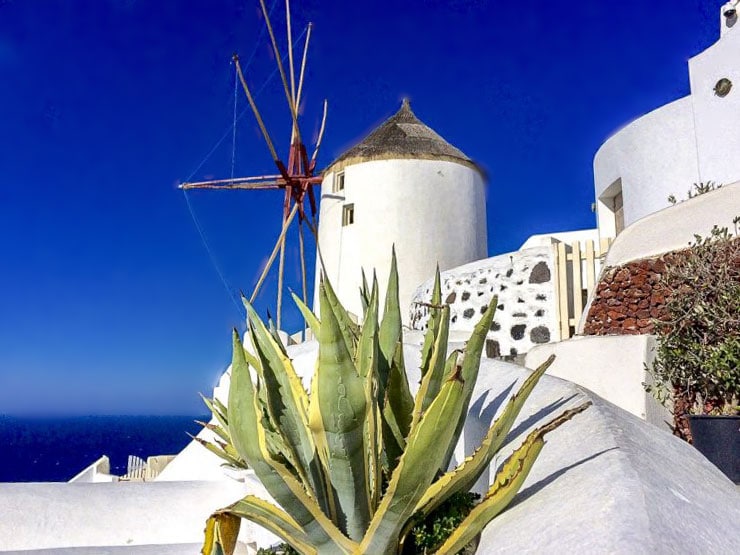 Blue and white buildings with a windmill on Santorini in winter