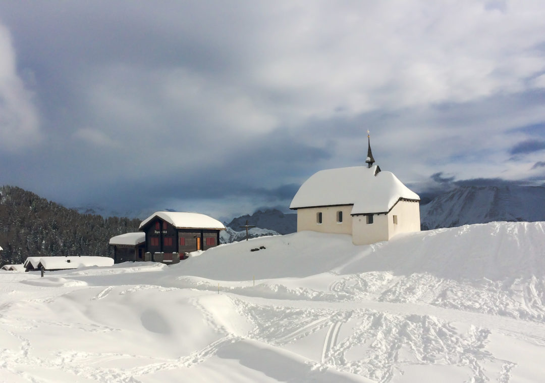 Snow-covered-white-church-on-a-mountain-top