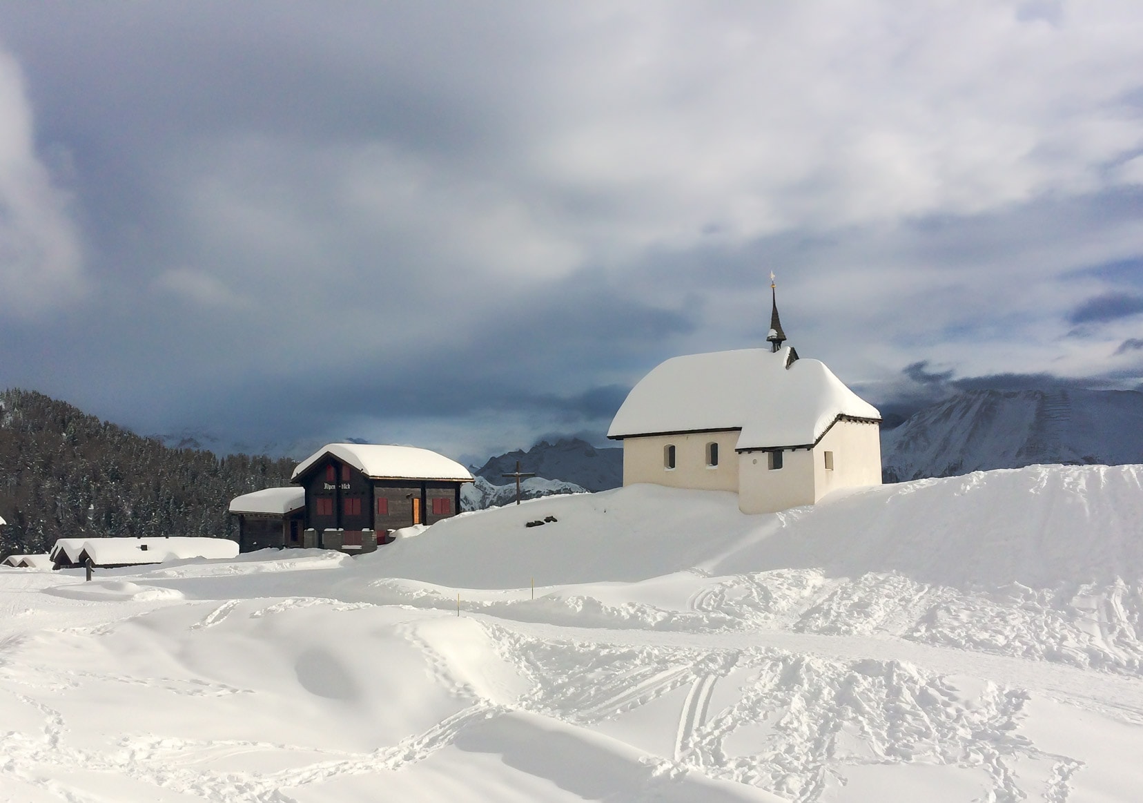 Snow-covered-white-church-on-a-mountain-top inBettmeralp