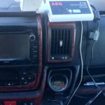 motorhome tip for beginners no. 7 Campervan dashboard showing a white inverter connected to the 12V socket