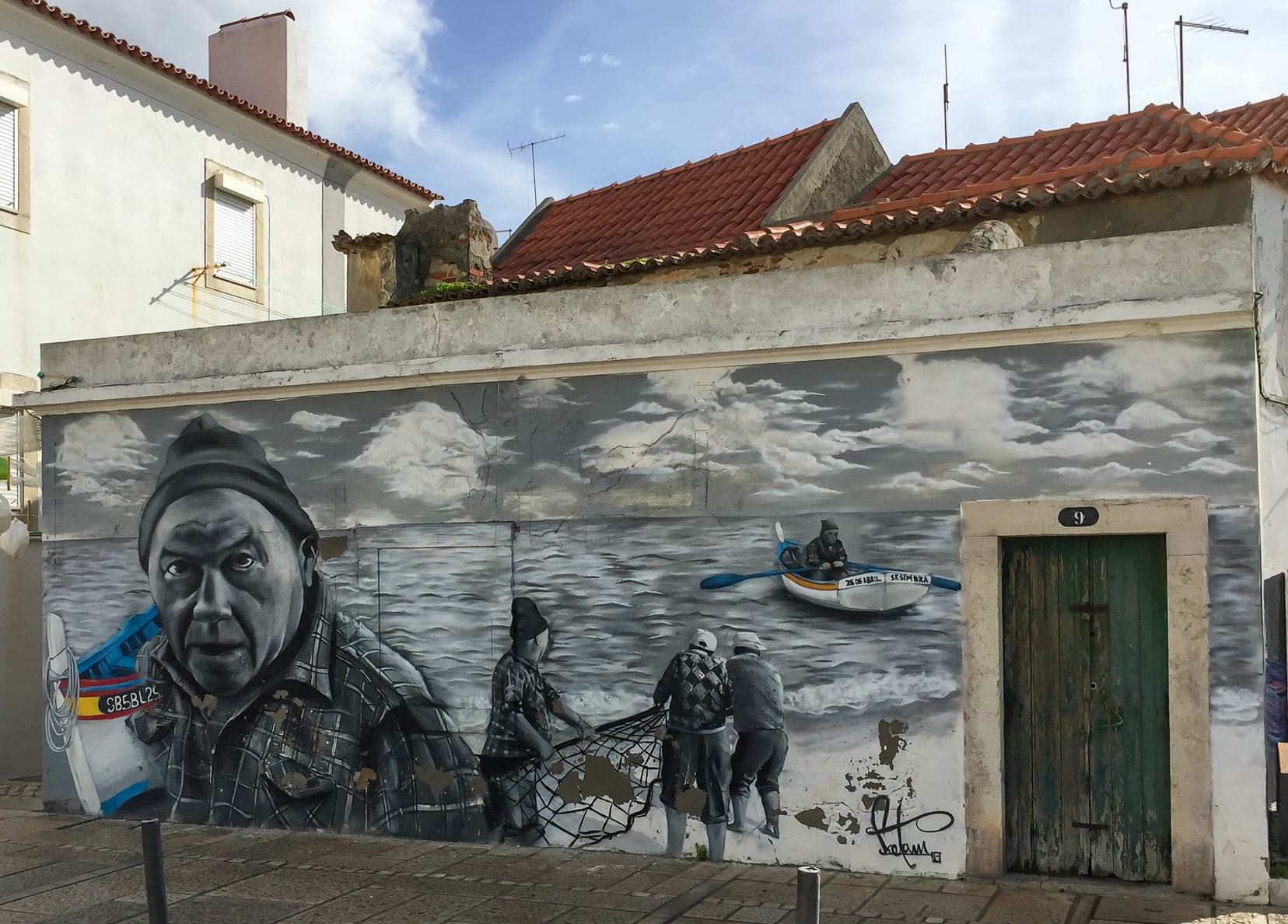 Street Art in Sesimbra depicting traditional fishing village life