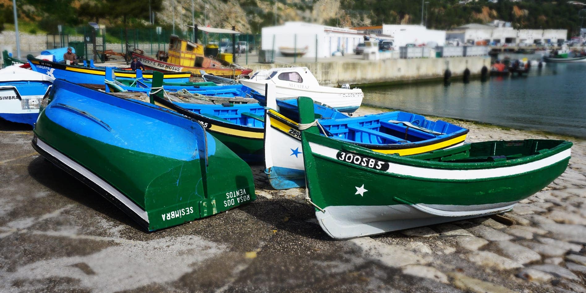 sesimbra boats in the marina green and yellow