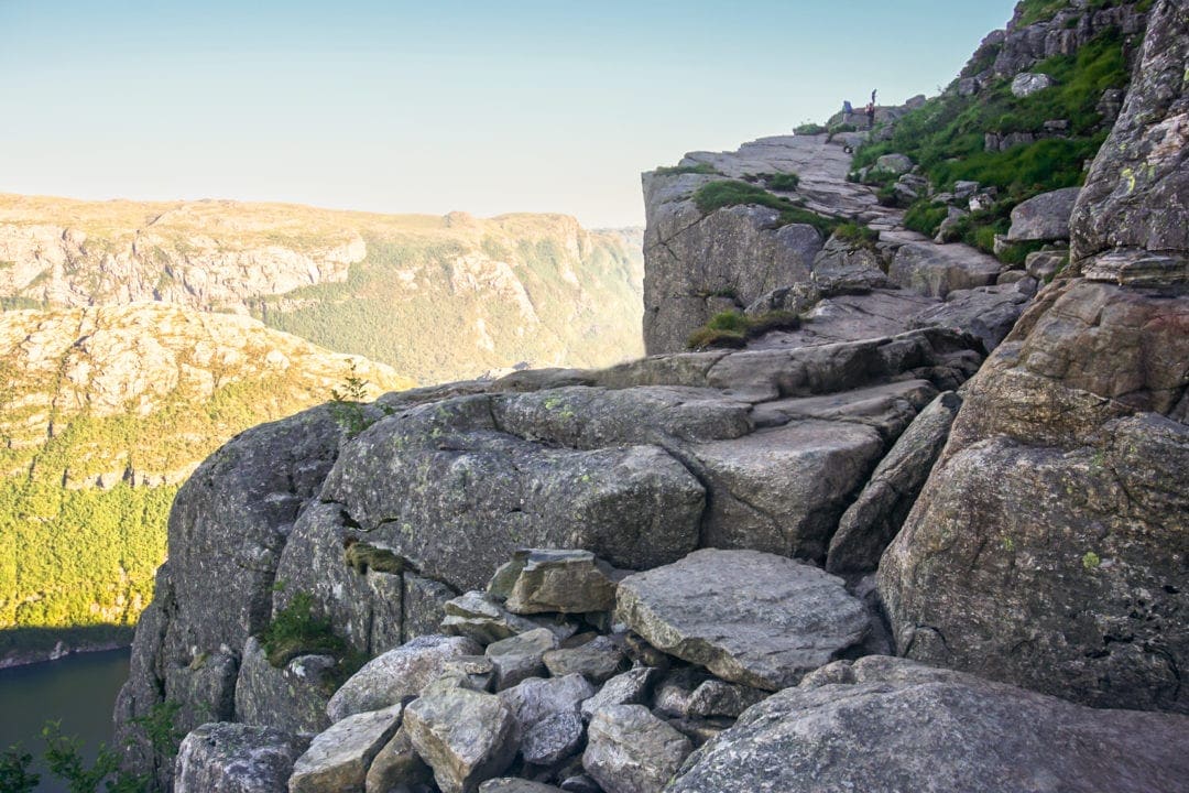 Rocky pathway beside cliff with fjord below