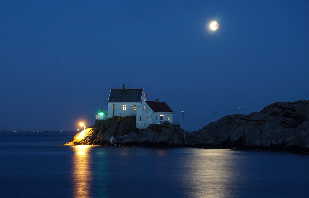 moon above lighthouse 