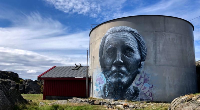 A large water tank with a mural of Utsira first woman Mayor