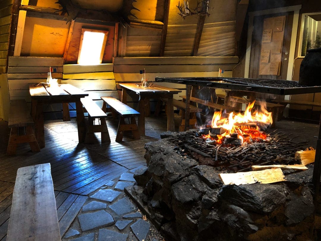 inside the cafe at nutti sami siida - fireplace and wooden benches