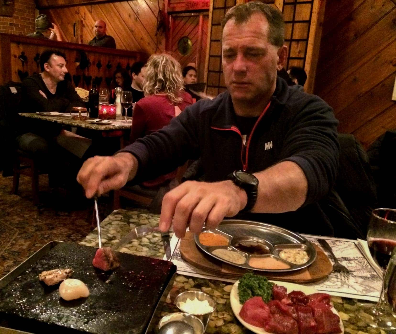 Lars eating a selection of meats at grizzlys restaurant