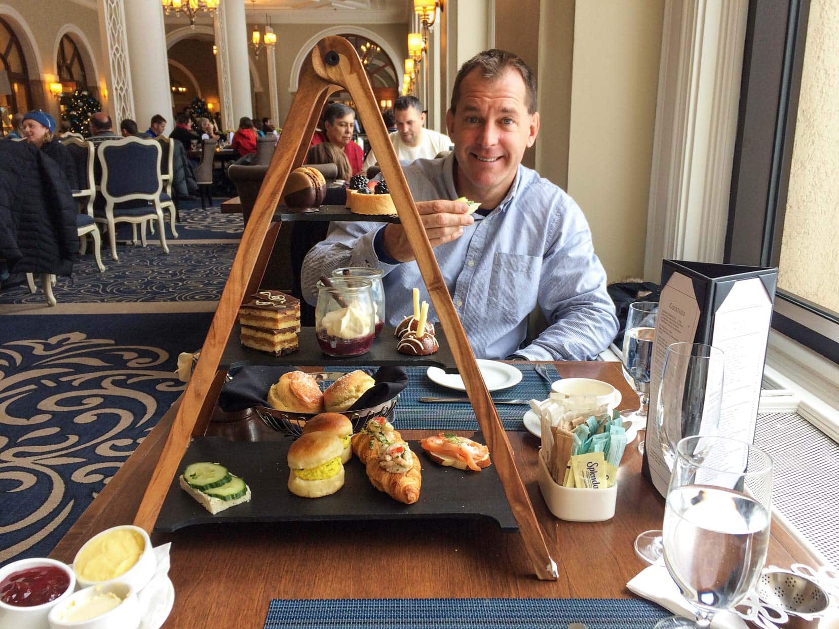 Christmas-in-Banff-High-tea Lars with a tray filled with goodies