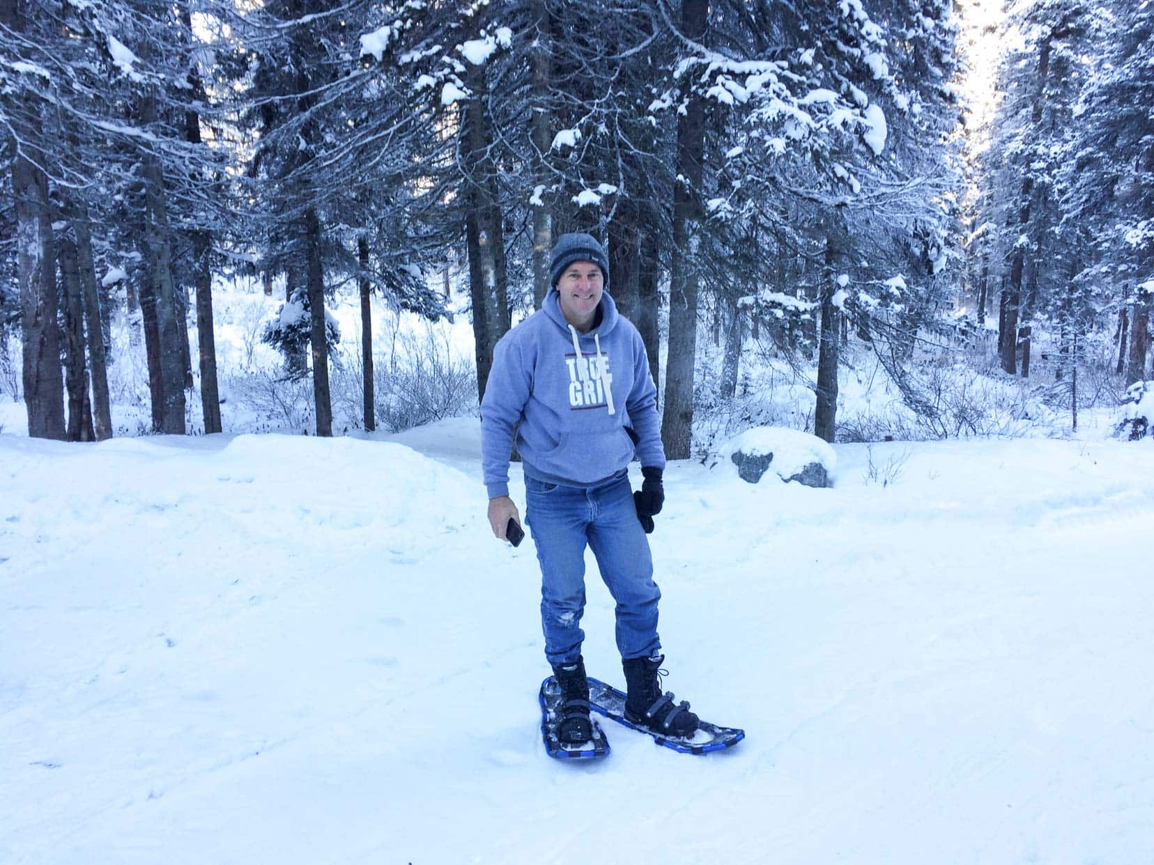 Lars stood in snowy forest with snowshoes on