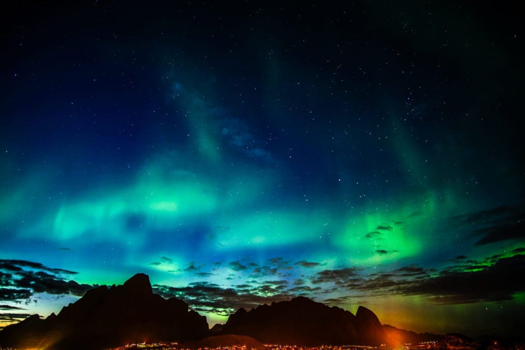 Green northern lights across the sky in Lofoten