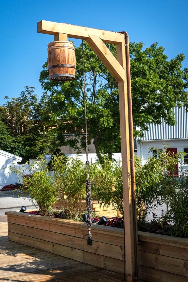 Bade-Olena Shower - wooden pole with shower head that looks like a barrel