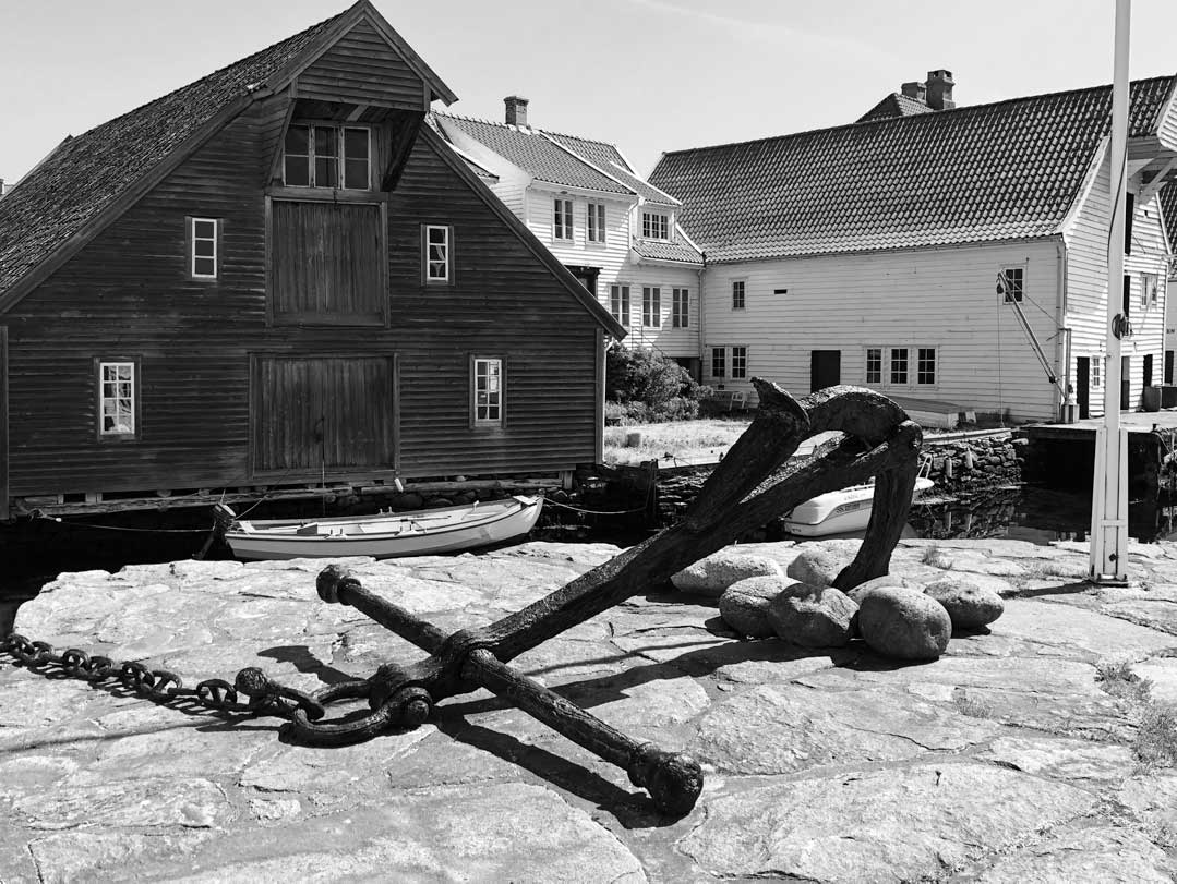 Black and white photo of boathouse and anchor in Skudeneshavn