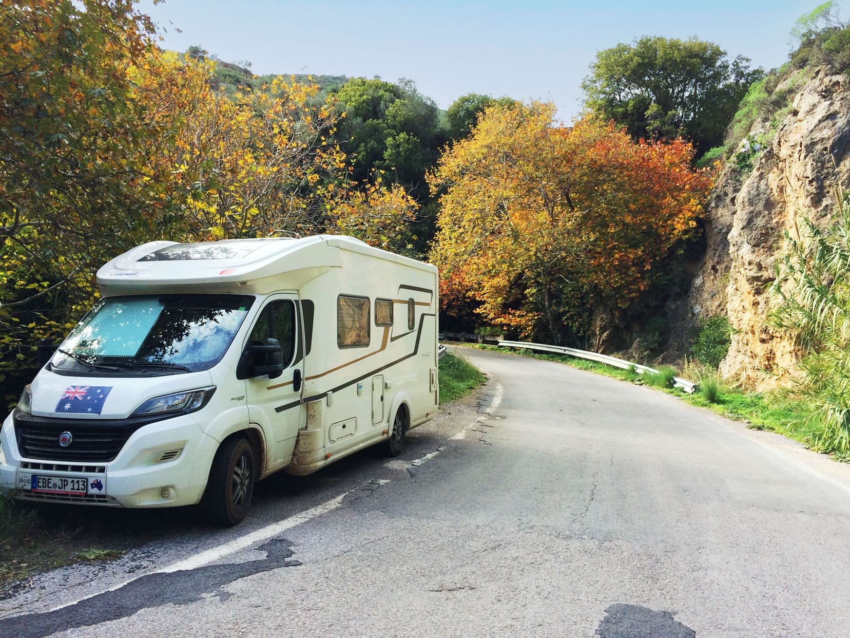 Motorhome parked by the side of the road which seems very narrow