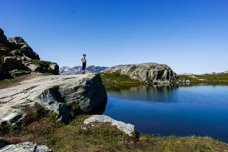 Shelley stood on rock overlooking a mountain lake