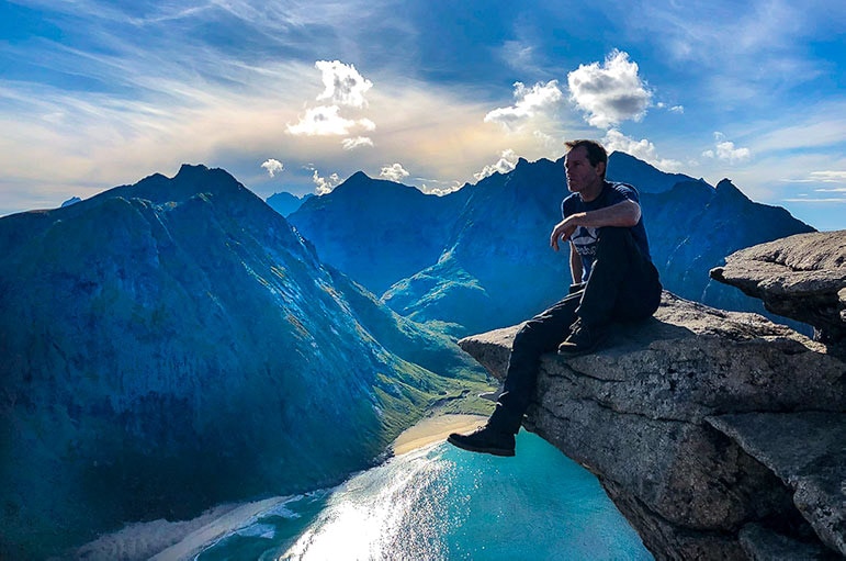 Ryten Hike - Man on rock overlooking Kvalvika Beach