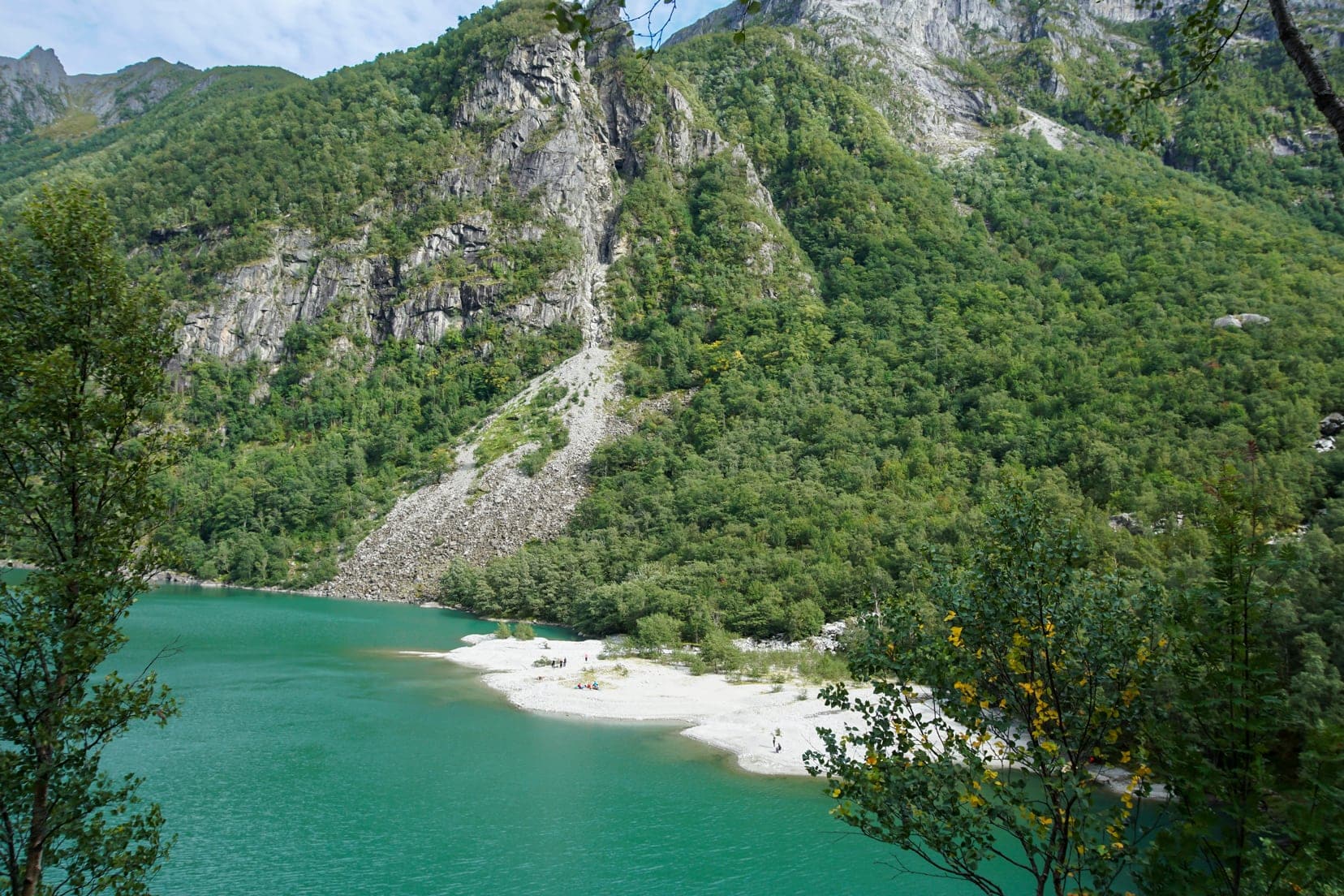 Green waters of a lake with surrounding mountains