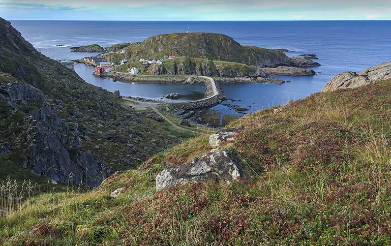 A view looking over Nyksund with it's buildings and windy road - Dronningruta Hike
