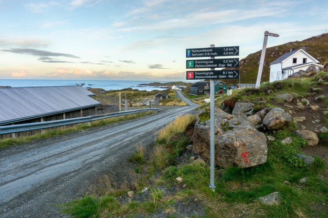 sign beside a coastal road indicating a hike