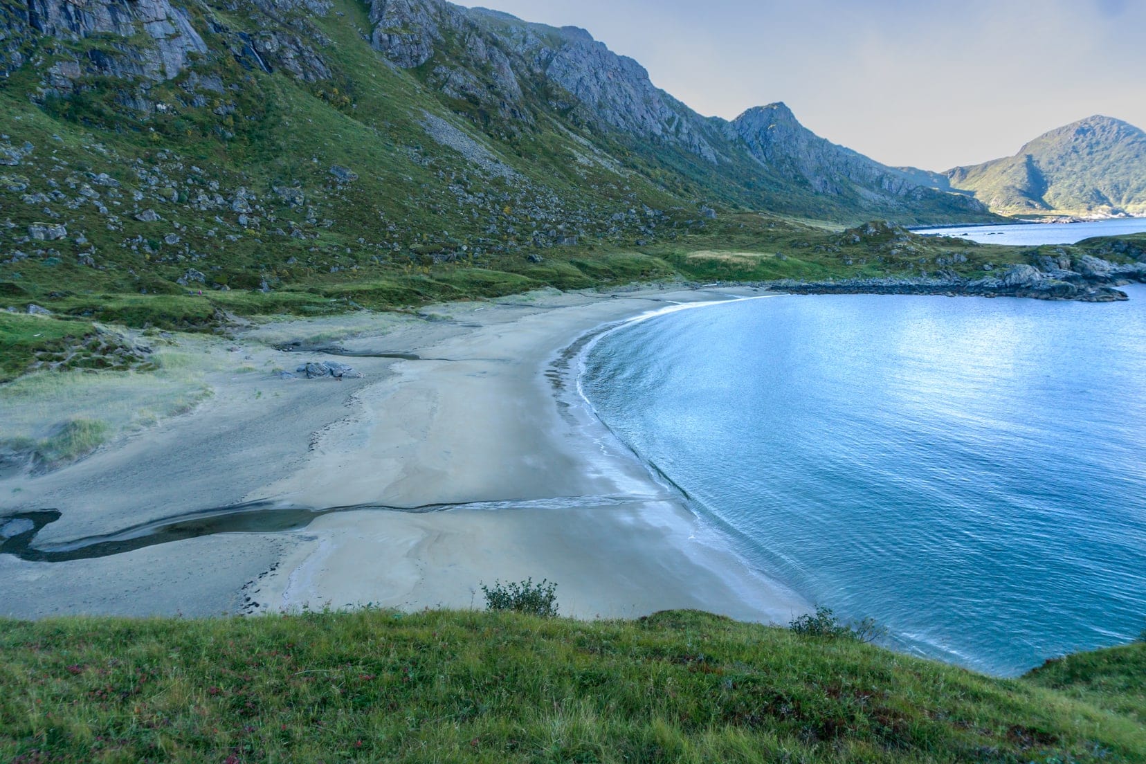 Sweeping beach with mountain backdrop