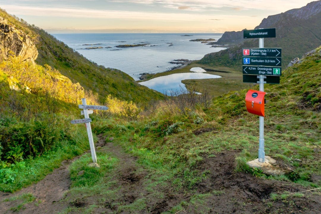 mountain trail markers with sea backdrop