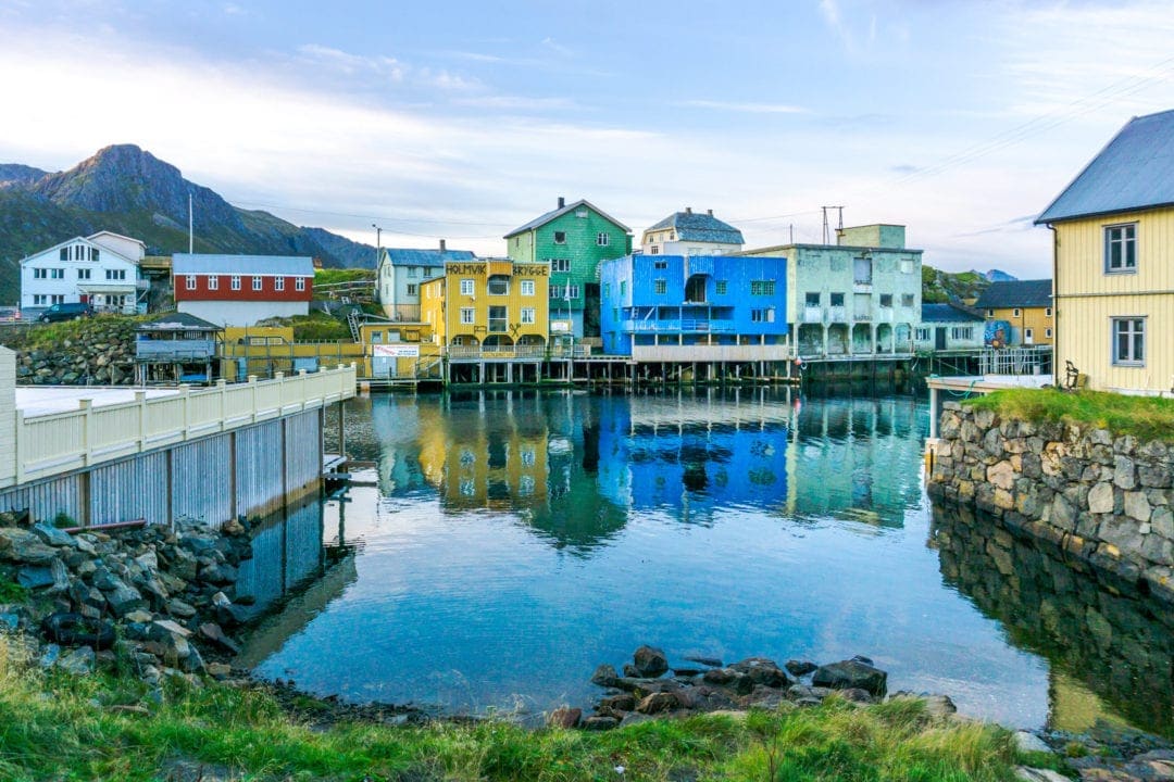 coloured buildings seen across a river 