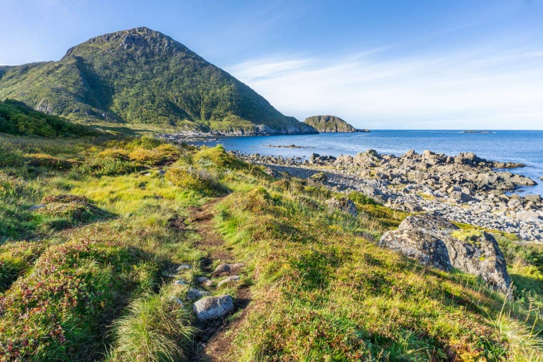 flat coastal path leading to a mountain