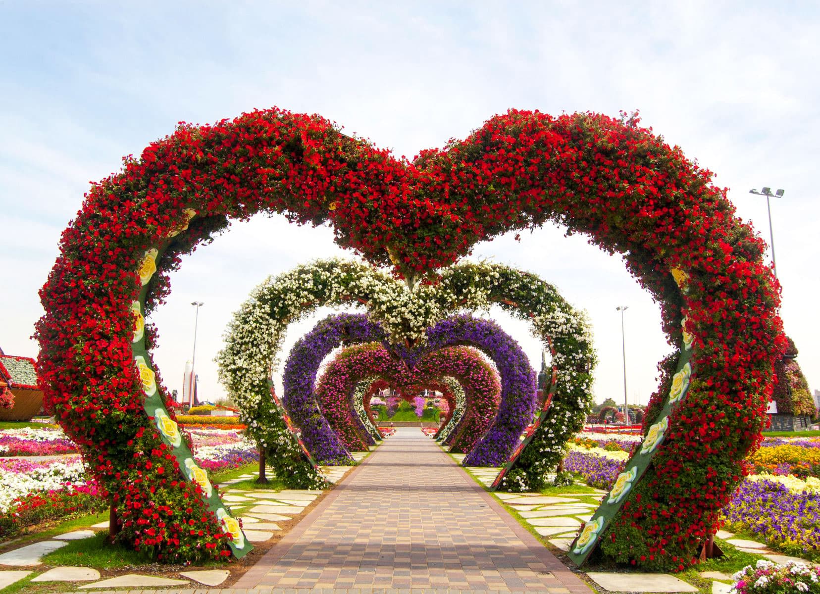 Flower covered heart arches all along a road  