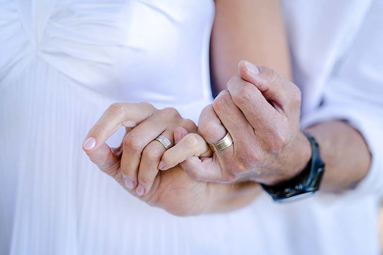 Holding Hands with wedding rings on