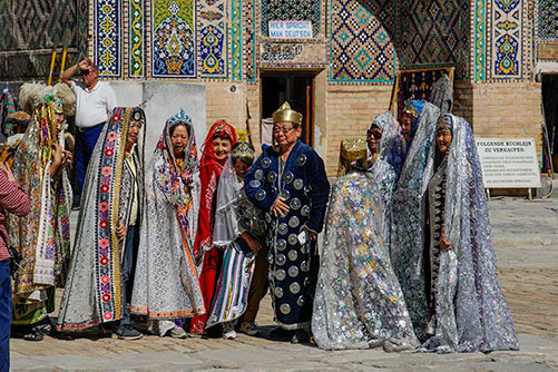 Some tourists wearing the Uzbek traditional dress-up costumes