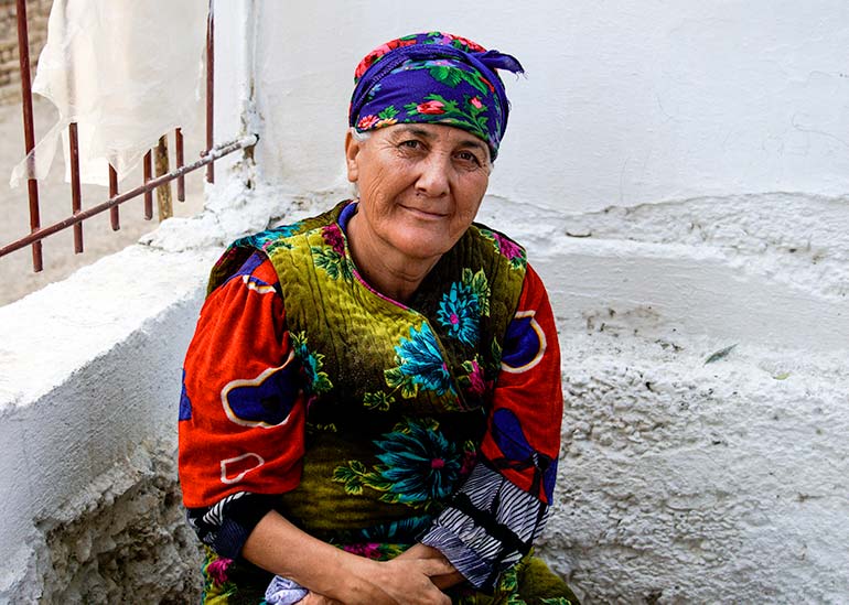 Uzbekistan woman wearing bright clothing and headscarf