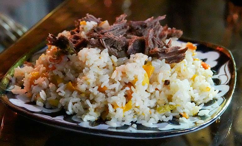 National dish of Uzbekistan - Plov with rice and meat on tip