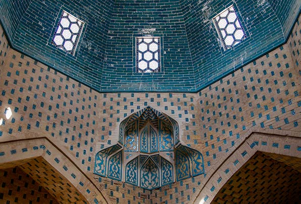 Ornate mausoleum with green/blue mosaics