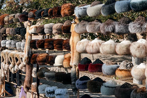 Different coloured fur hats on sale at Khiva's markets