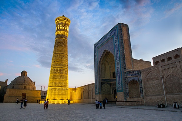 Illuminated Kalyon minaret at sunset 