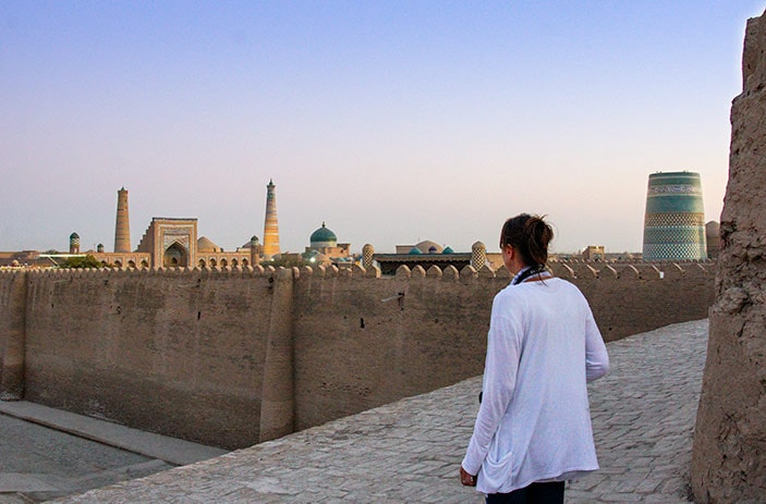 Lady overlooking Khiva old city from the city walls