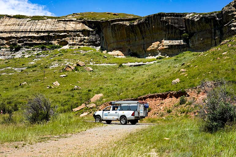 photo of our car on south africa road Driving in Golden Gate National Park, South Africa