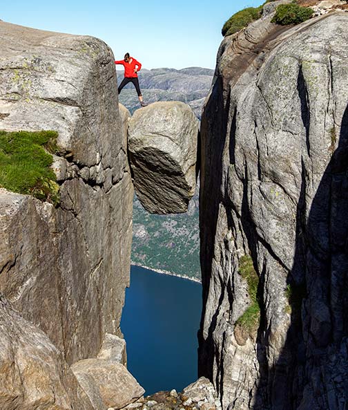 Shelley stepping on to Kjeragbolten Boulder