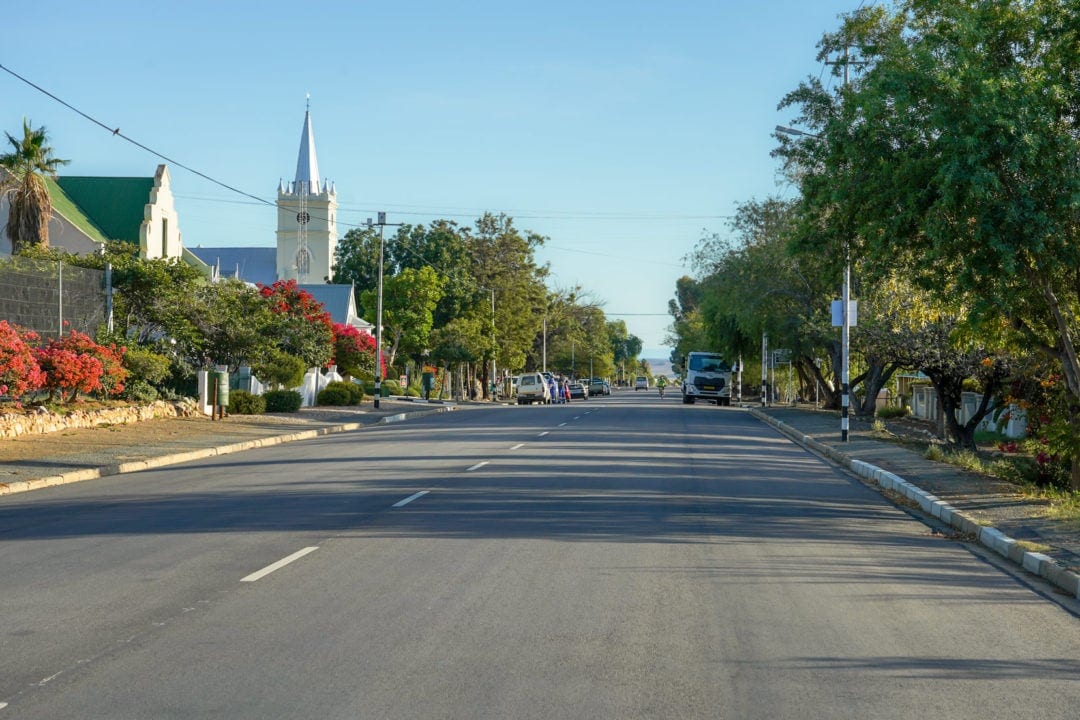 a town main street with buildings on the side