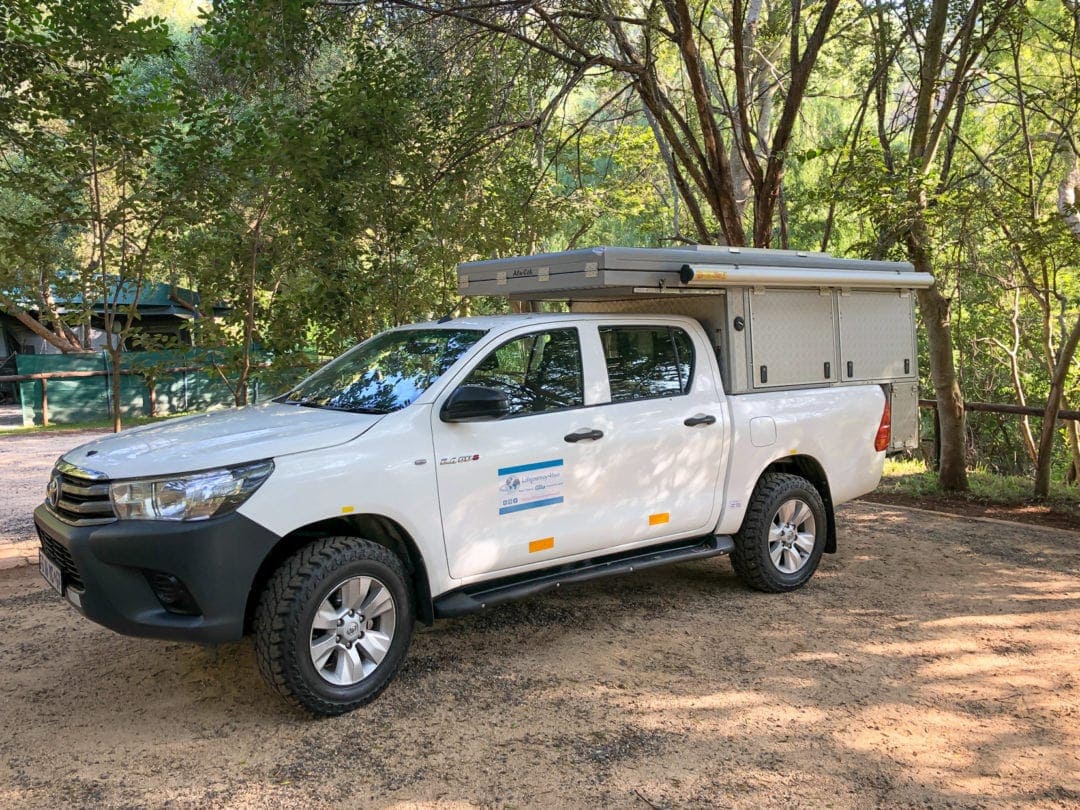 4wd parked under a tree