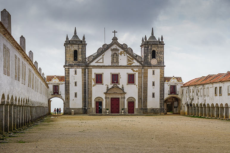 Sanctuario de nossa white adn red brick building with two sides of arched accommodation. 