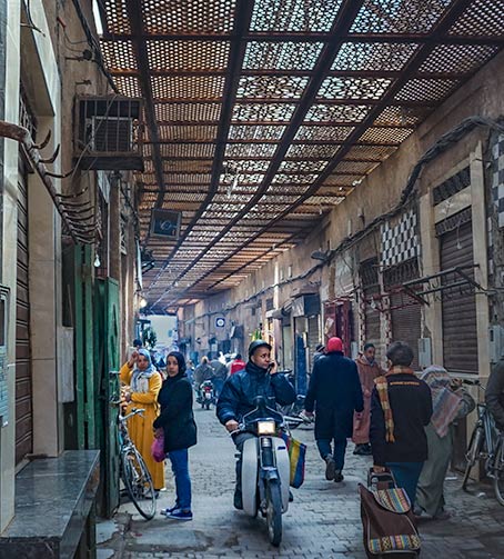 Motorbike and rider inside the crowded Souk, Marrakech Tips