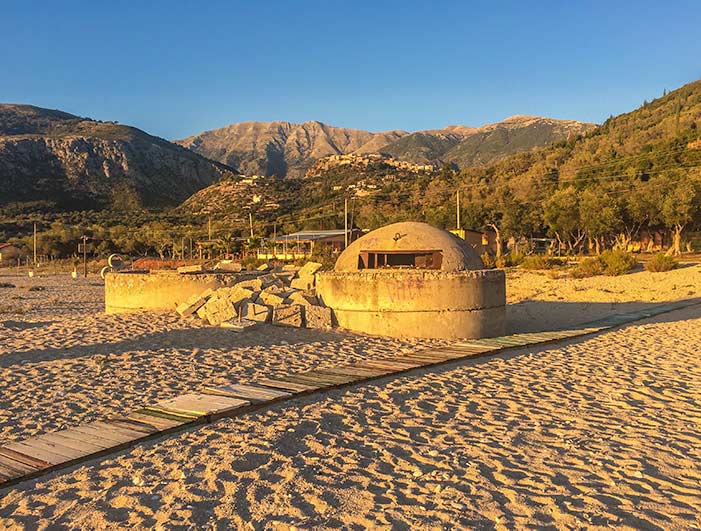 Albanian beach at sunset with a bunker facing at to sea