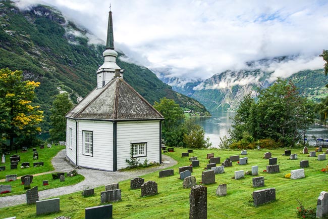 white octagonal church overlooking a fjord 