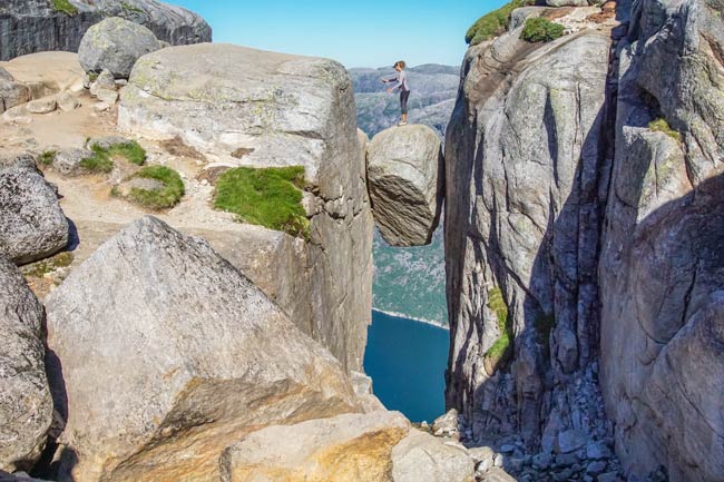 Kjeragbolten rock with a woman stood on the rock